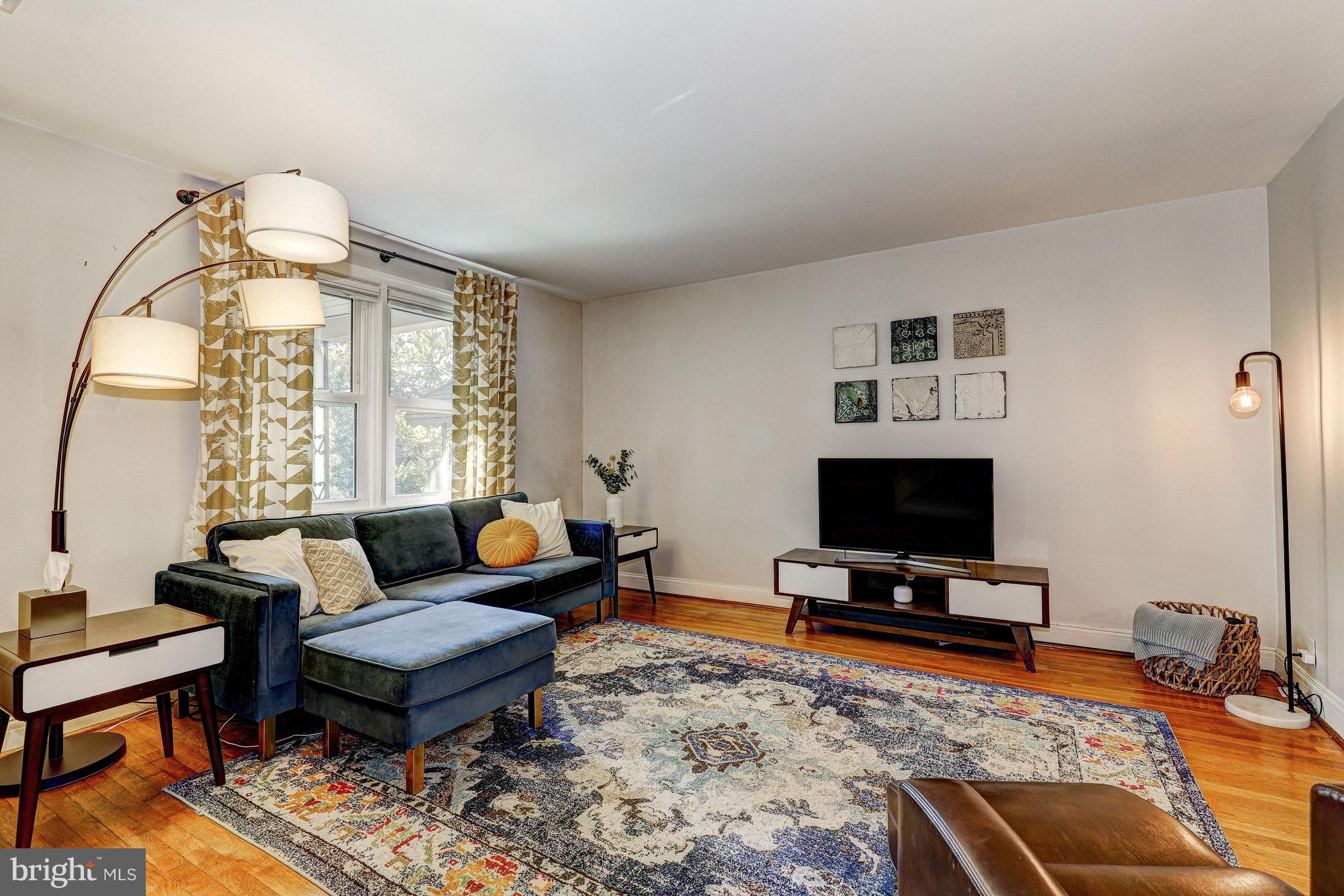 3908 Rexmere Road Baltimore, MD 21218 - Photo 2 of 39 a living room with furniture and a flat screen tv