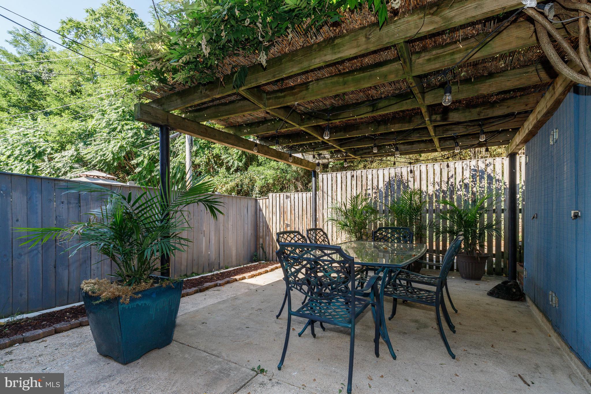 3908 Rexmere Road Baltimore, MD 21218 - Photo 24 of 39 a view of patio with table and chairs potted plants