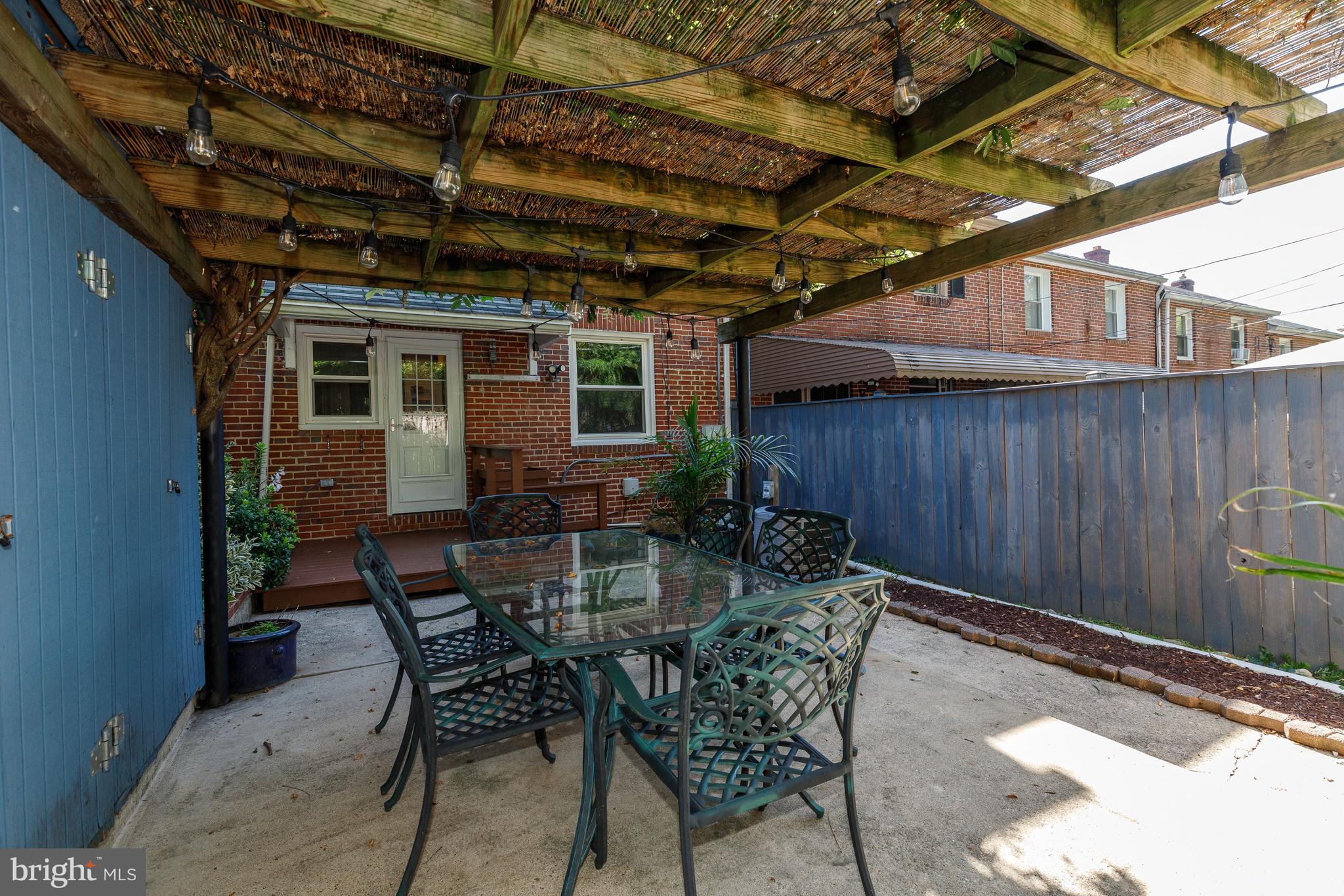 3908 Rexmere Road Baltimore, MD 21218 - Photo 28 of 39 a view of a backyard with a patio and wooden fence