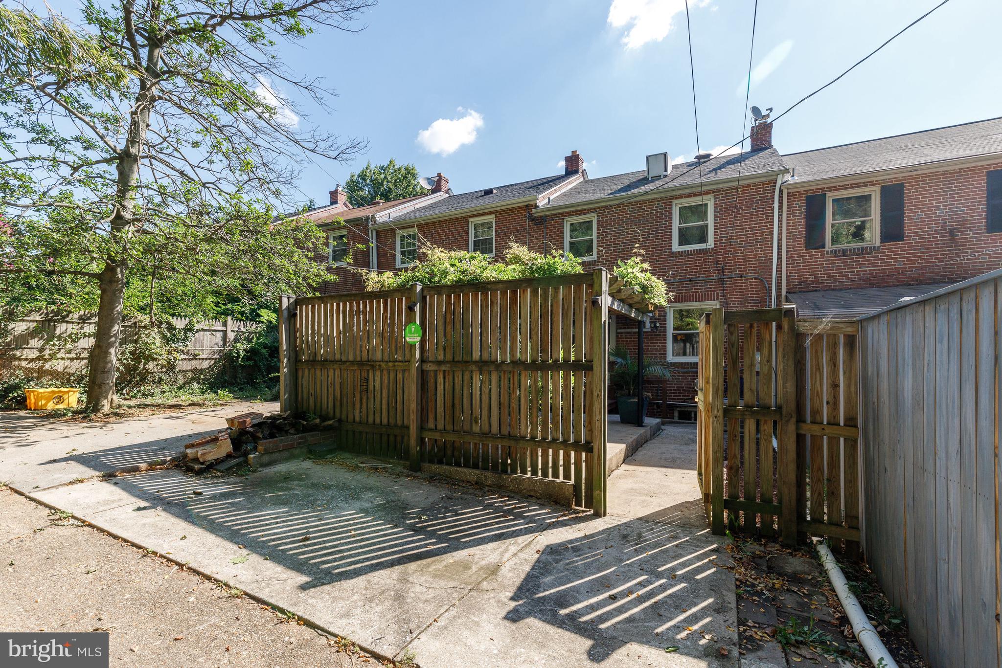 3908 Rexmere Road Baltimore, MD 21218 - Photo 29 of 39 a view of a house with a small yard and wooden fence