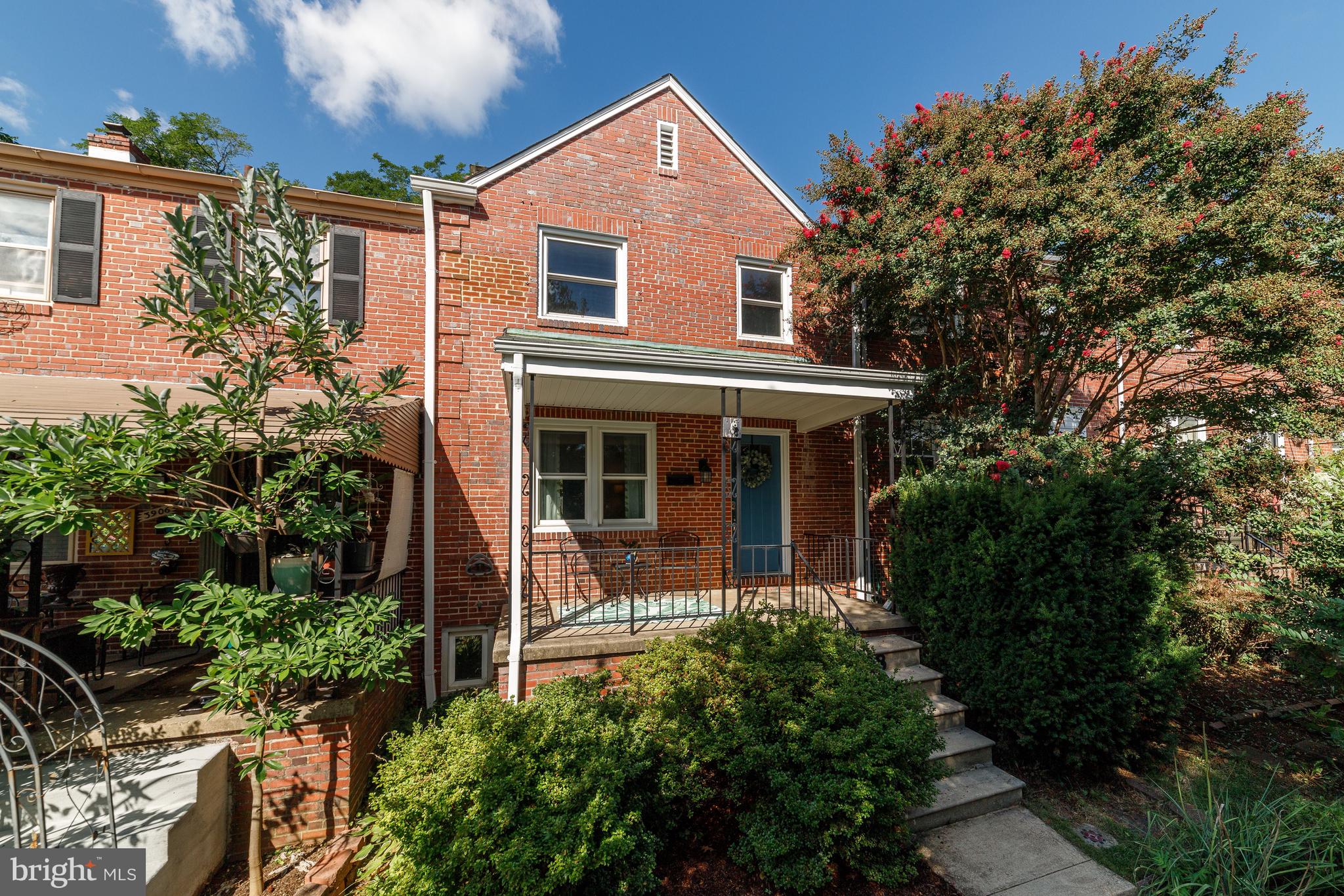 3908 Rexmere Road Baltimore, MD 21218 - Photo 38 of 39 a front view of a house with a yard and potted plants
