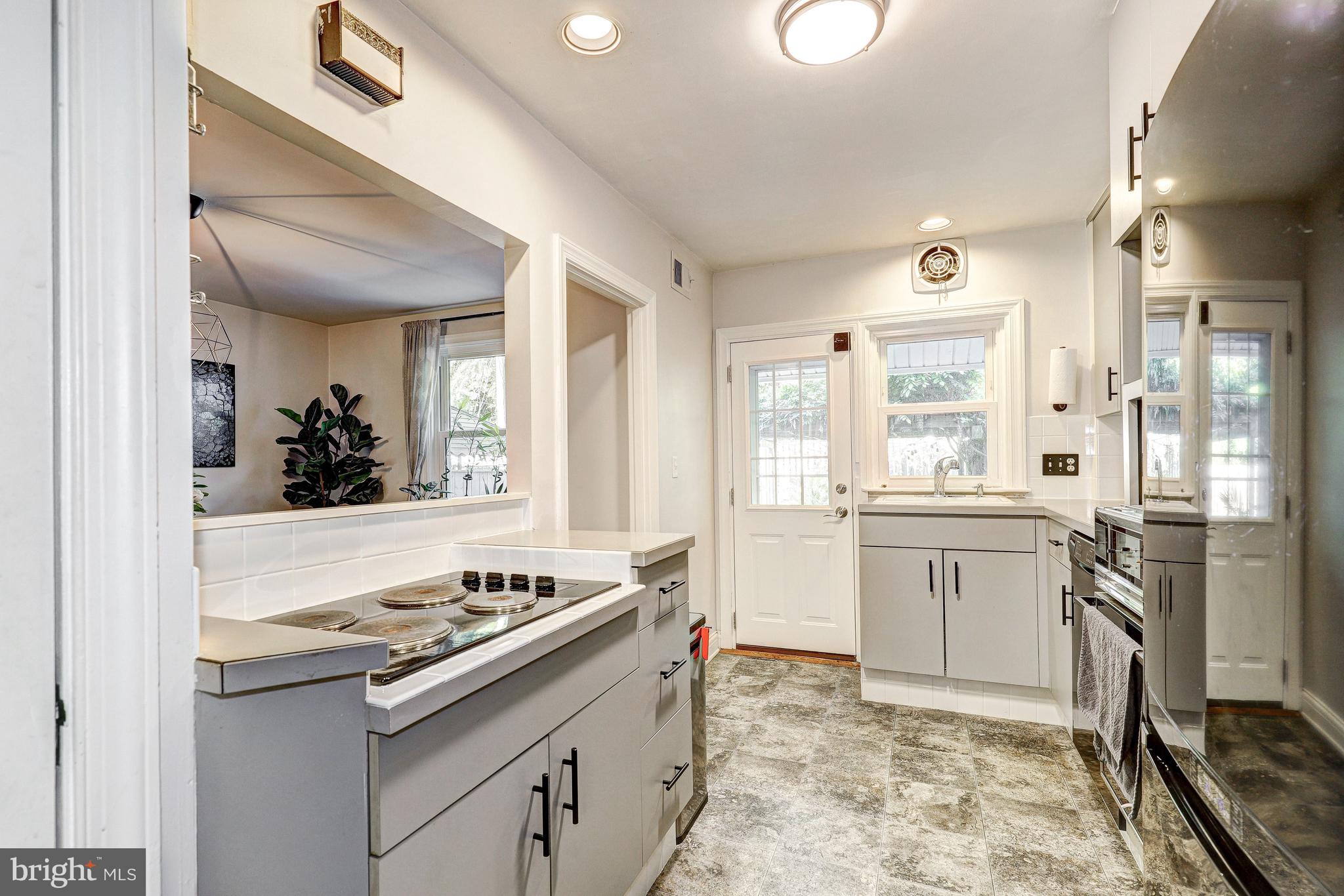 3908 Rexmere Road Baltimore, MD 21218 - Photo 4 of 39 a kitchen with a sink stove and refrigerator