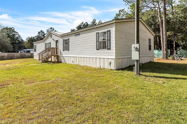a view of a house with a yard and garage
