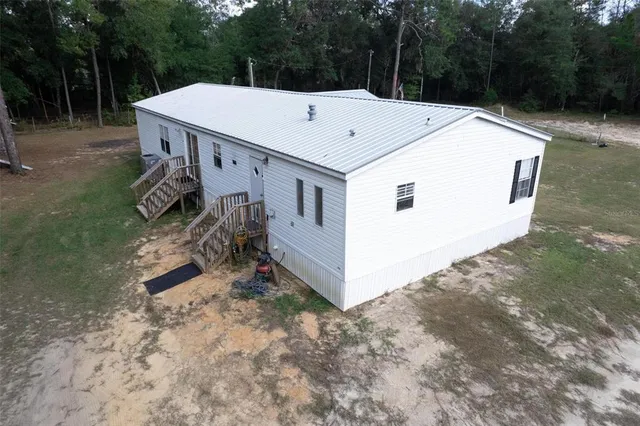 a view of a house with a sink and backyard