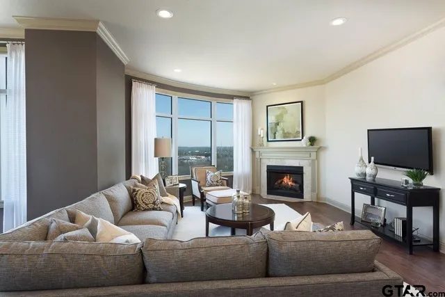 a living room with furniture a fireplace and a flat screen tv