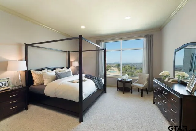 a bedroom with a bed and large window