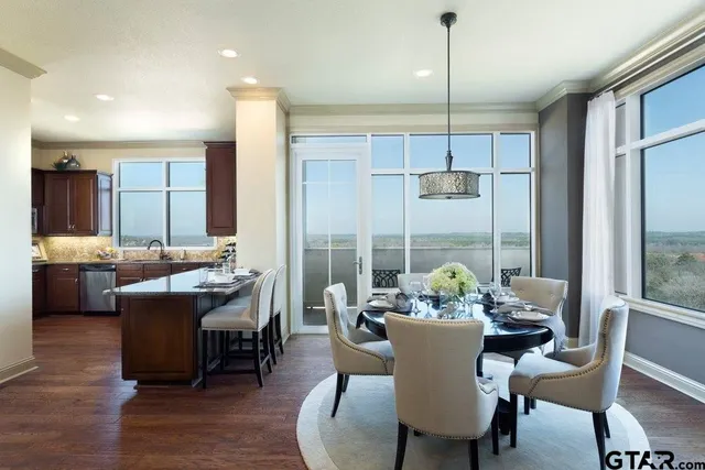 a dining room with furniture a chandelier and wooden floor