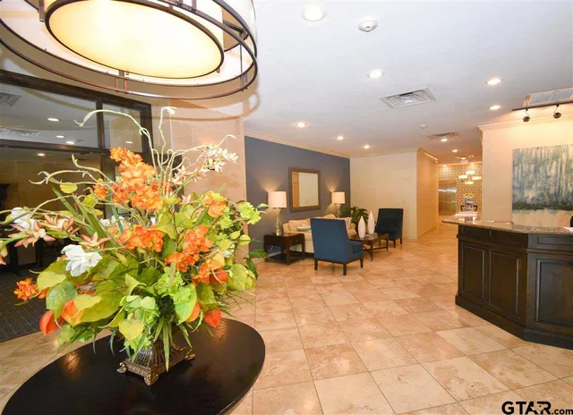 a lobby with furniture and a potted plant