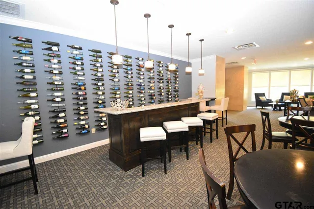 a living room with furniture a rug and a chandelier