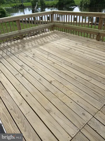 a view of a wooden deck and a yard