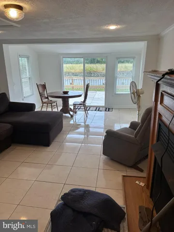a backyard of a house with lots of green space and wooden fence