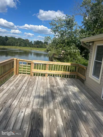 a view of a lake with houses in back