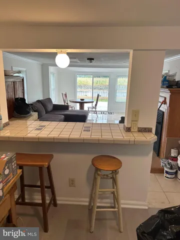 a kitchen with a table chairs and a refrigerator