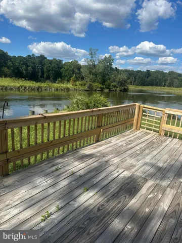 a view of a wooden deck with a lake