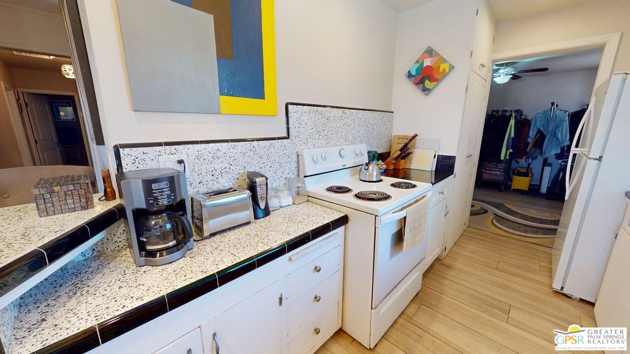 14701 Old Morongo Road Whitewater, CA 92282 - Photo 26 of 70 a kitchen with stainless steel appliances granite countertop a sink and a wooden floor