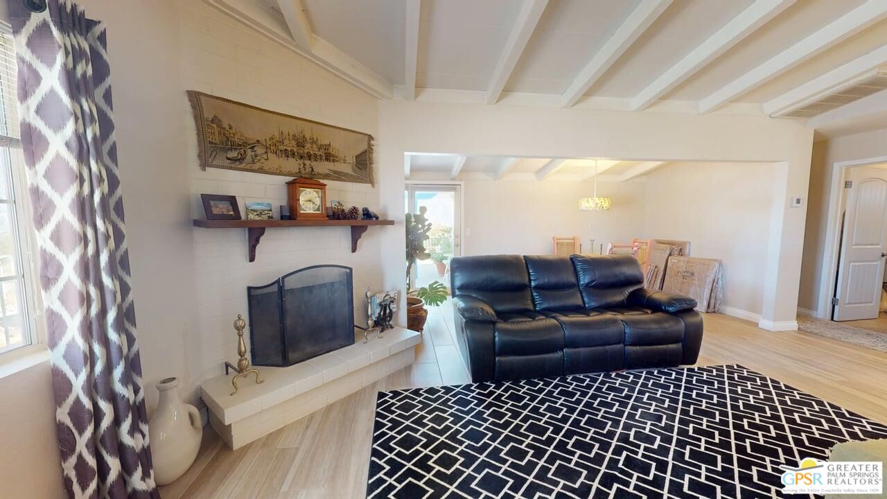 14701 Old Morongo Road Whitewater, CA 92282 - Photo 29 of 70 a living room with furniture a flat screen tv and a fireplace