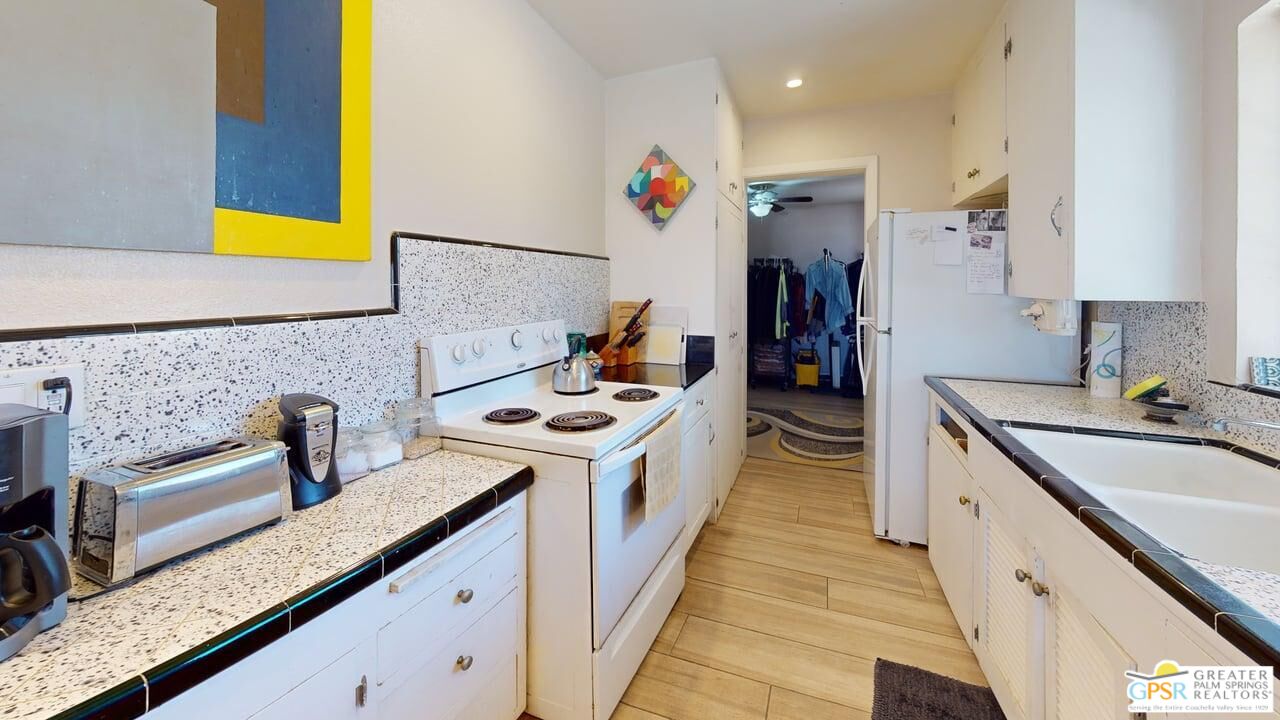 14701 Old Morongo Road Whitewater, CA 92282 - Photo 30 of 70 a kitchen with stainless steel appliances granite countertop a sink and a stove