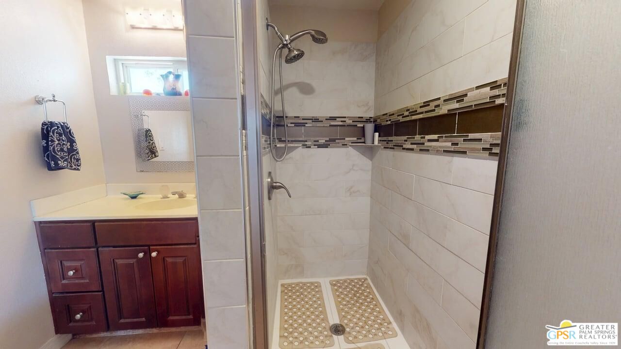 14701 Old Morongo Road Whitewater, CA 92282 - Photo 43 of 70 a bathroom with a shower sink and mirror