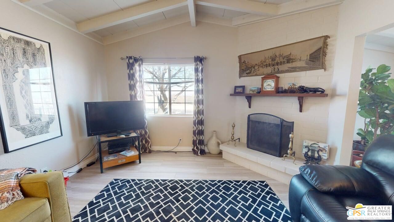 14701 Old Morongo Road Whitewater, CA 92282 - Photo 5 of 70 a living room with furniture a fireplace and a flat screen tv
