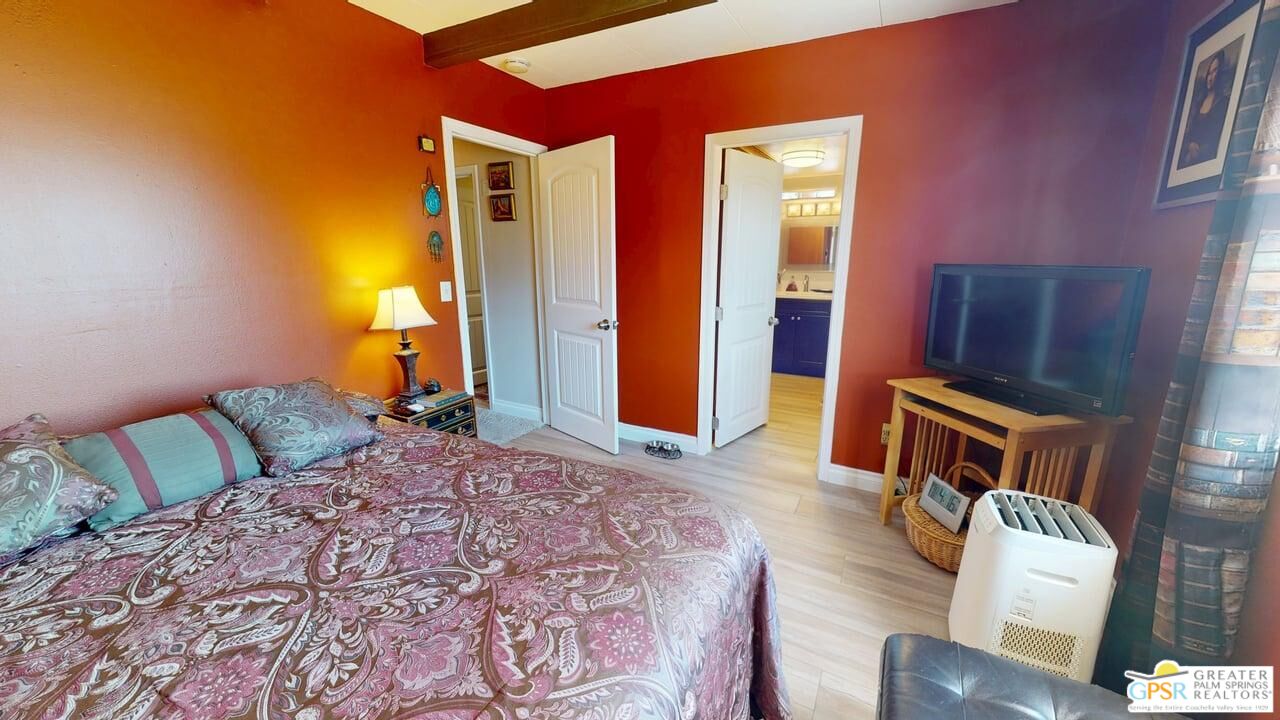 14701 Old Morongo Road Whitewater, CA 92282 - Photo 53 of 70 a bedroom with a bed and wooden floor