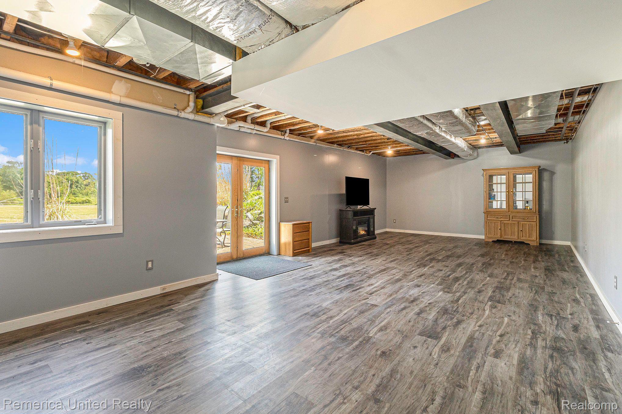 8722 North Gregory Road Fowlerville, MI 48836 - Photo 27 of 35 Lower Level Rec Room w/Door to Patio
