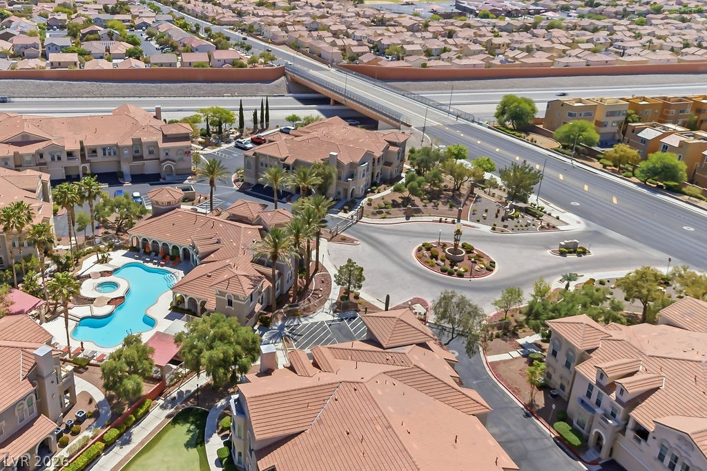10550 West Alexander Road, Unit 2133 Las Vegas, NV 89129 - Photo 19 of 42 An aerial view showcases a vibrant community featuring a resort-style pool and meticulously landscaped grounds.