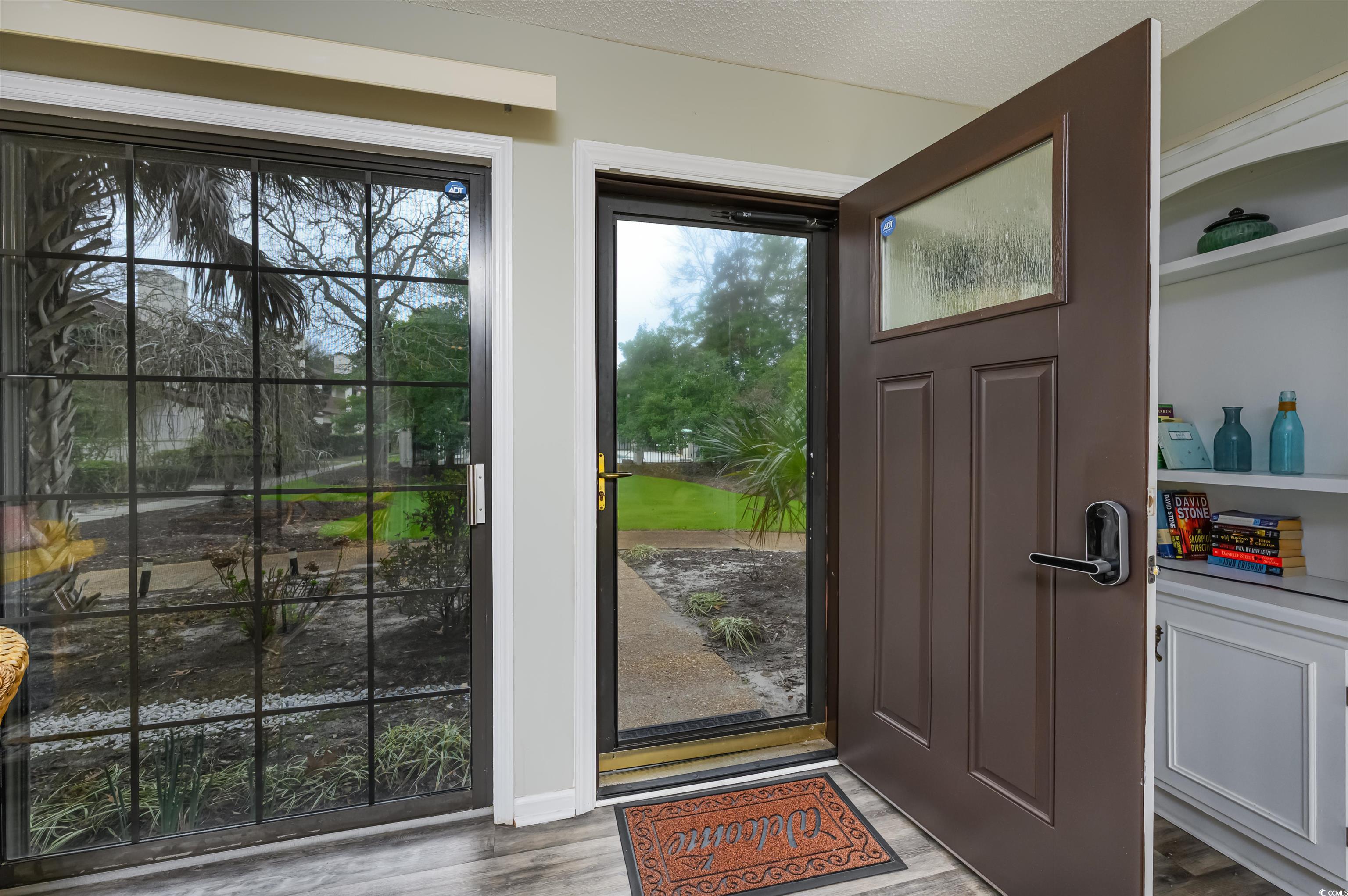 415 Queens Road, Unit B Myrtle Beach, SC 29572 - Photo 3 of 40 Doorway featuring wood finished floors and a textu