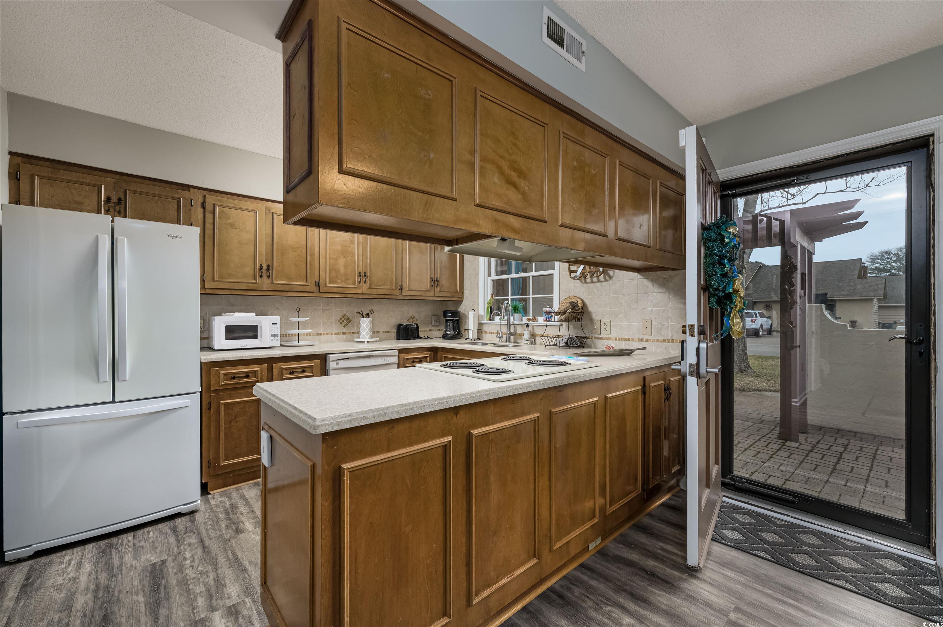 415 Queens Road, Unit B Myrtle Beach, SC 29572 - Photo 8 of 40 Kitchen featuring visible vents, wood finished flo