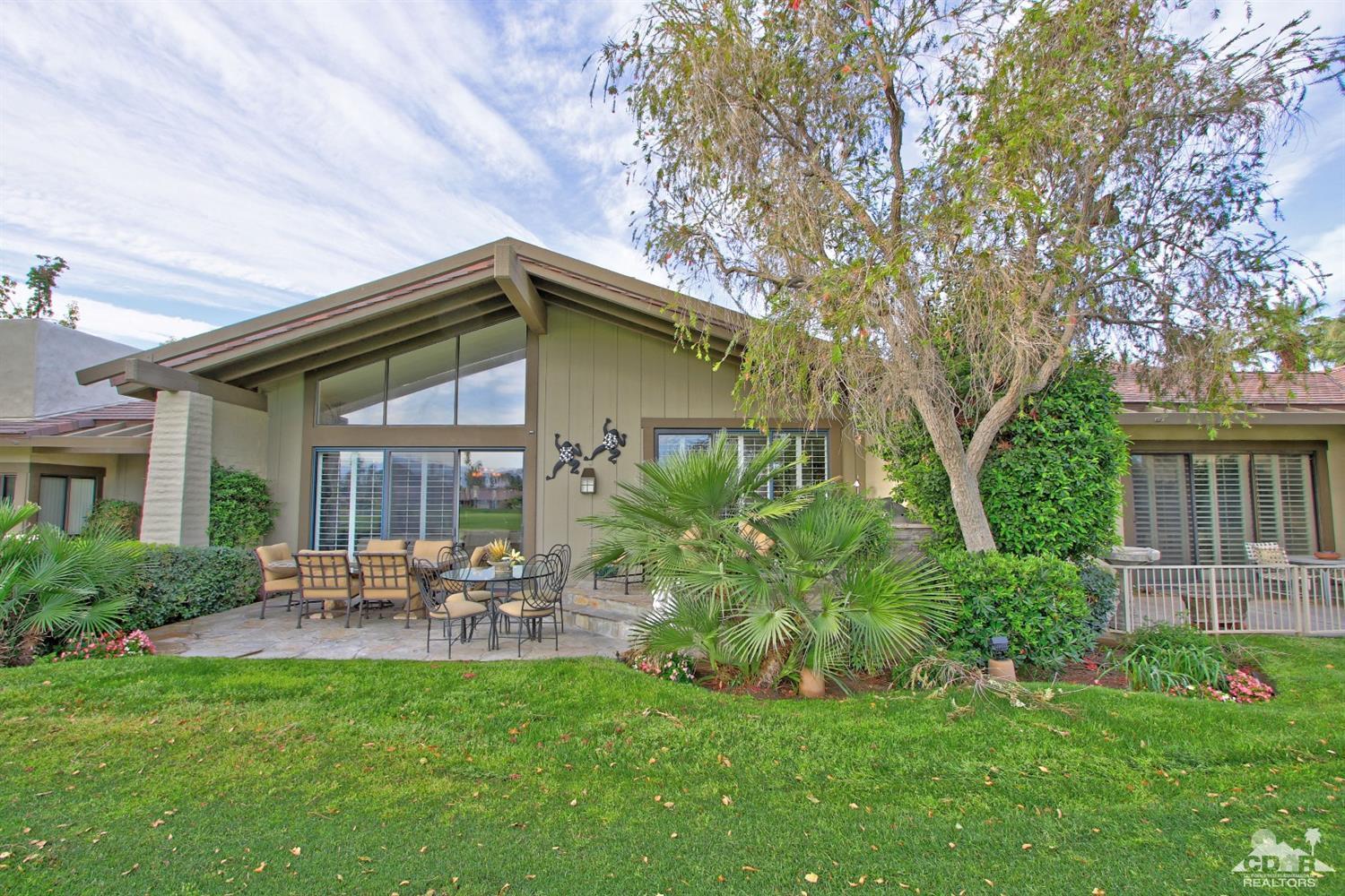326 Red River Road Palm Desert, CA 92211 - Photo 1 of 54 a backyard of a house with table and chairs plants and large tree