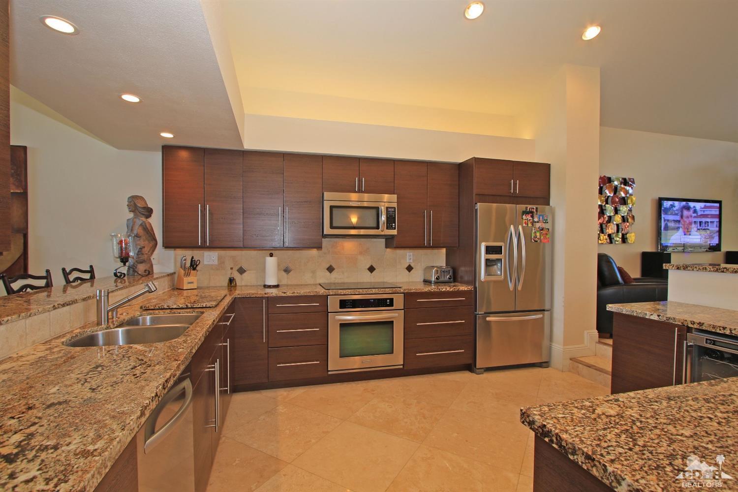 326 Red River Road Palm Desert, CA 92211 - Photo 16 of 54 a kitchen with stainless steel appliances granite countertop a sink stove and refrigerator