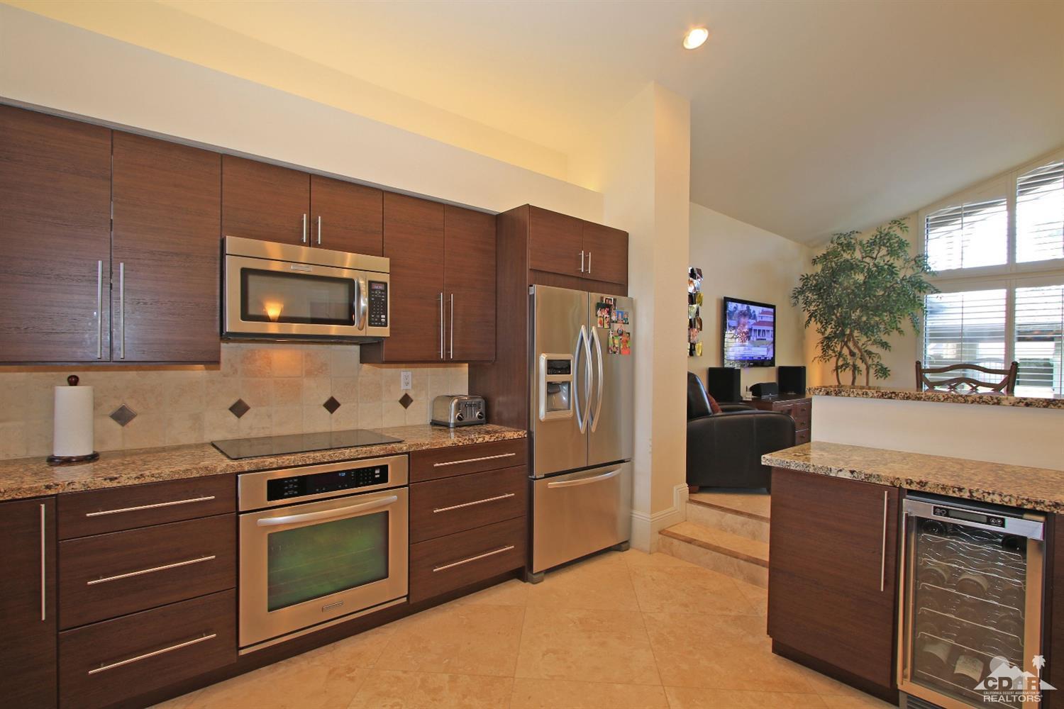 326 Red River Road Palm Desert, CA 92211 - Photo 17 of 54 a kitchen with stainless steel appliances granite countertop a refrigerator stove and oven
