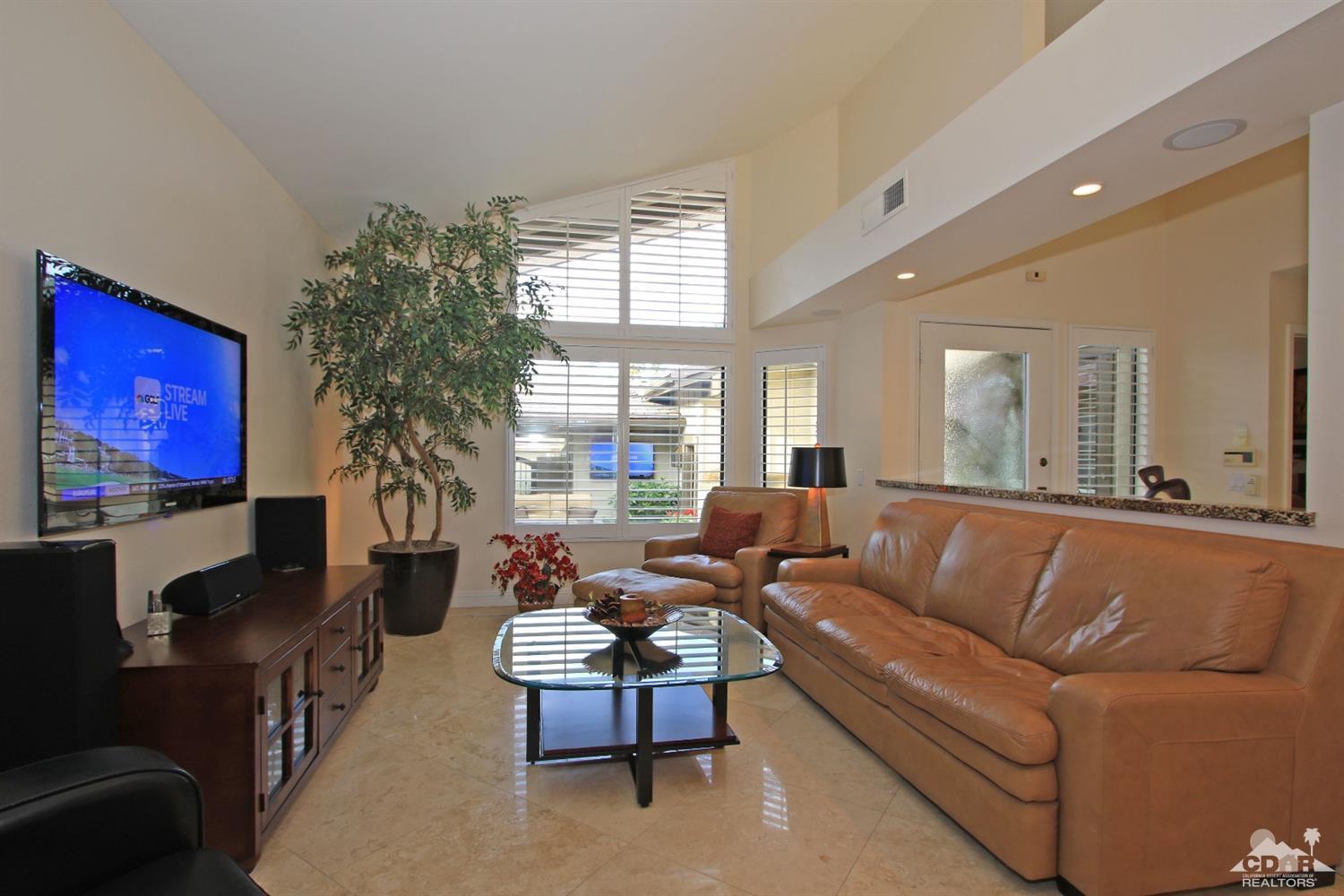 326 Red River Road Palm Desert, CA 92211 - Photo 21 of 54 a living room with furniture a large window and a flat screen tv