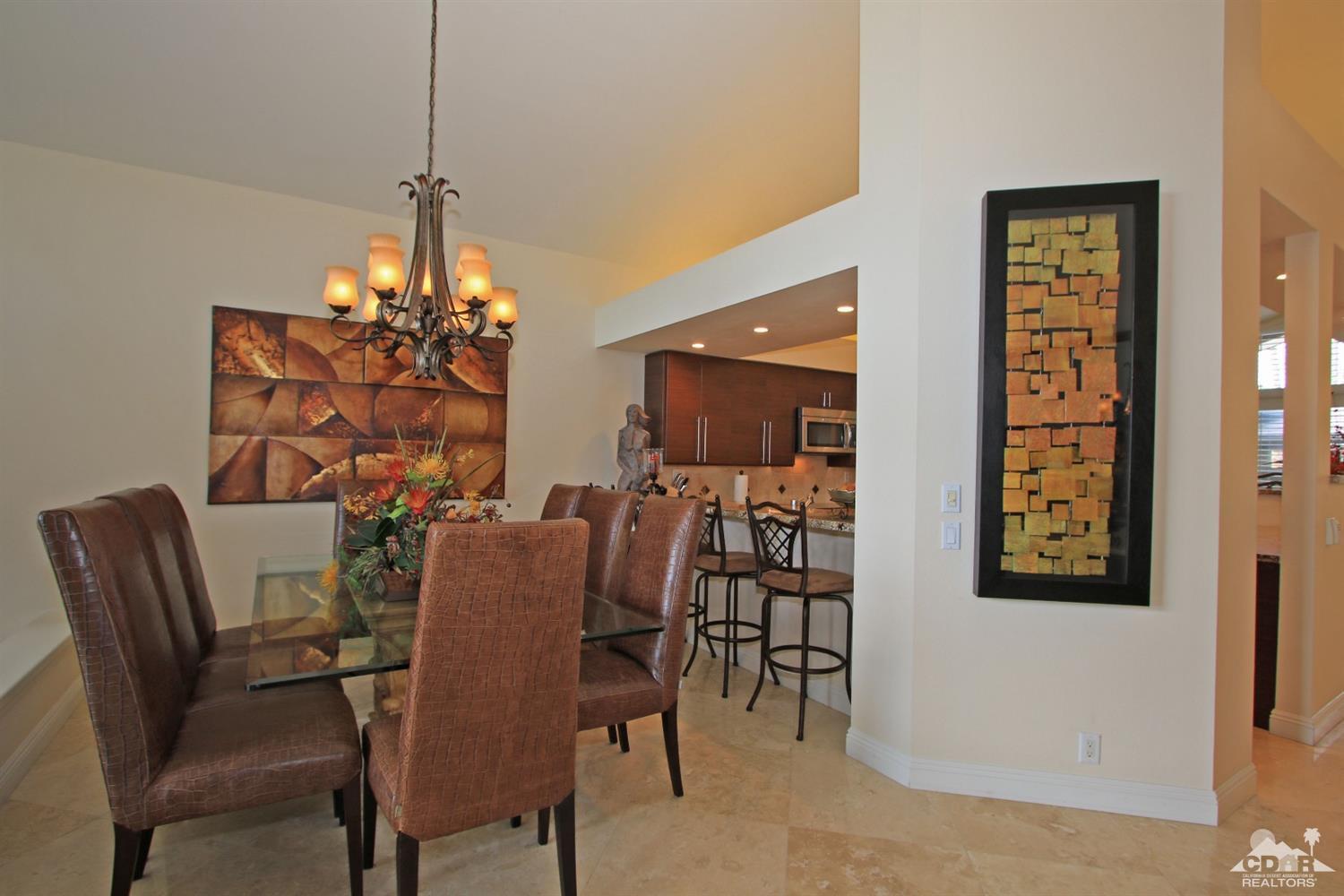 326 Red River Road Palm Desert, CA 92211 - Photo 25 of 54 a view of a dining room with furniture and chandelier