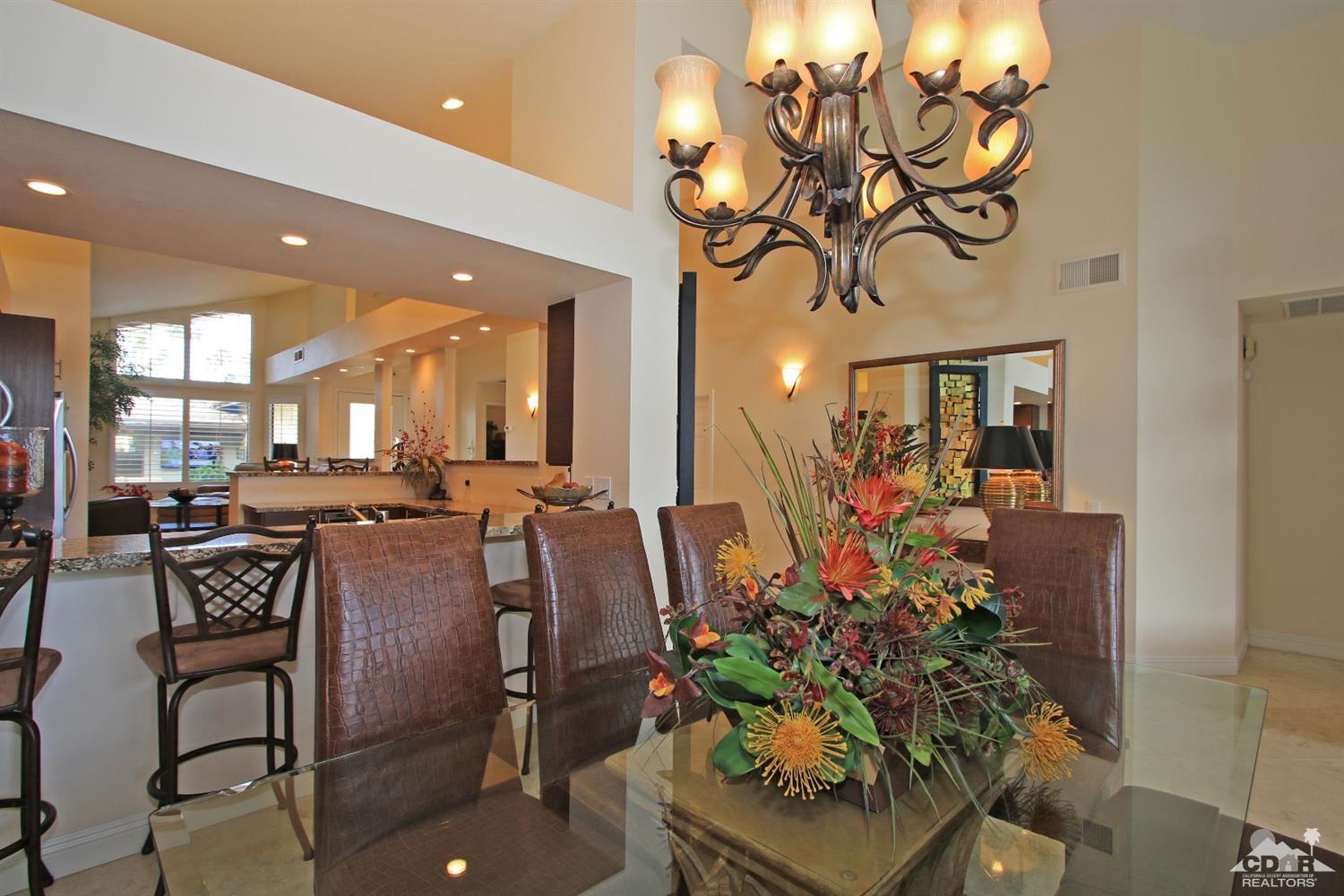 326 Red River Road Palm Desert, CA 92211 - Photo 28 of 54 a view of a dining room with furniture and a chandelier