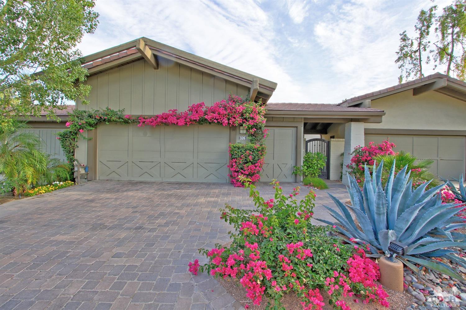 326 Red River Road Palm Desert, CA 92211 - Photo 4 of 54 a house with a flower garden in front of it