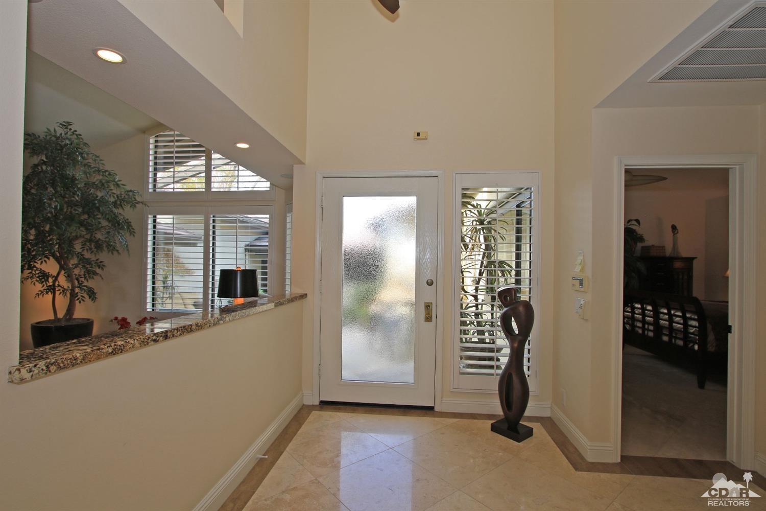 326 Red River Road Palm Desert, CA 92211 - Photo 31 of 54 a view of a hallway with bathroom and front door