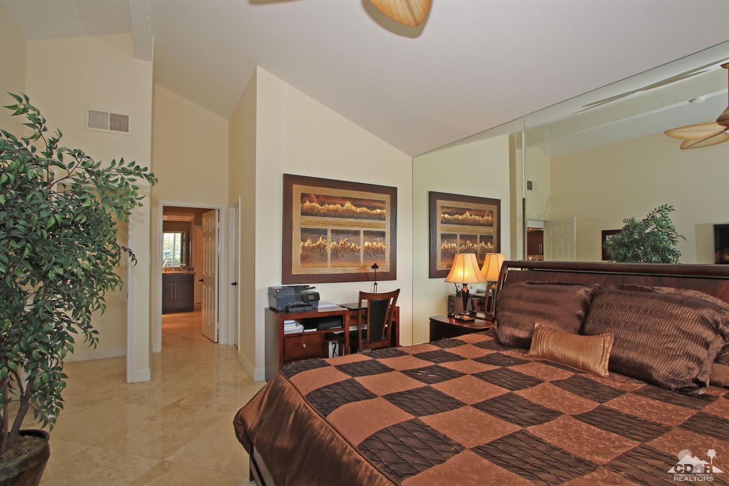 326 Red River Road Palm Desert, CA 92211 - Photo 34 of 54 a bedroom with a bed and wooden cabinets