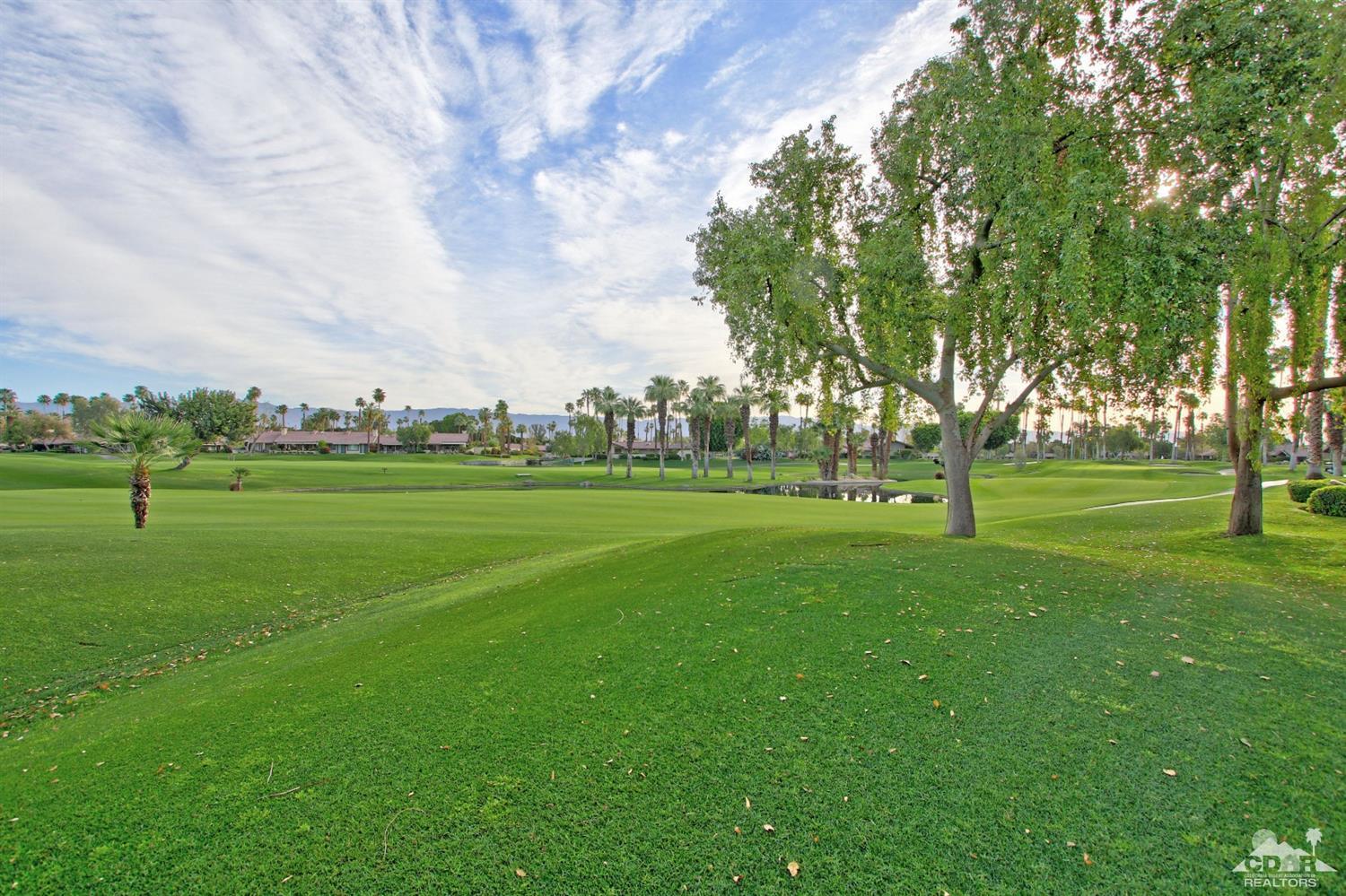 326 Red River Road Palm Desert, CA 92211 - Photo 47 of 54 a view of grassy field with benches and trees all around