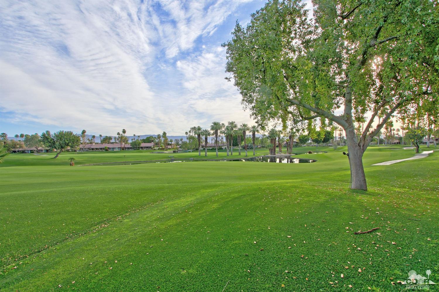 326 Red River Road Palm Desert, CA 92211 - Photo 53 of 54 a view of grassy field with benches and trees all around
