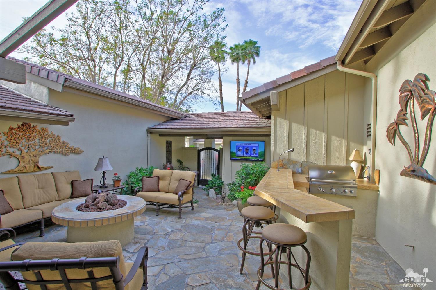 326 Red River Road Palm Desert, CA 92211 - Photo 54 of 54 a view of a patio with couches table and chairs and potted plants