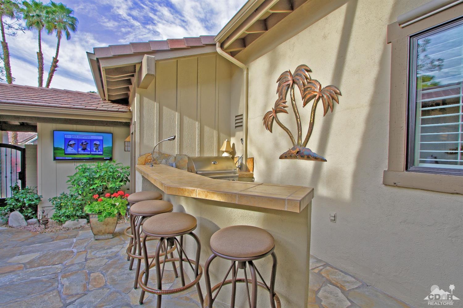 326 Red River Road Palm Desert, CA 92211 - Photo 7 of 54 a table and chairs in a patio and a potted plant