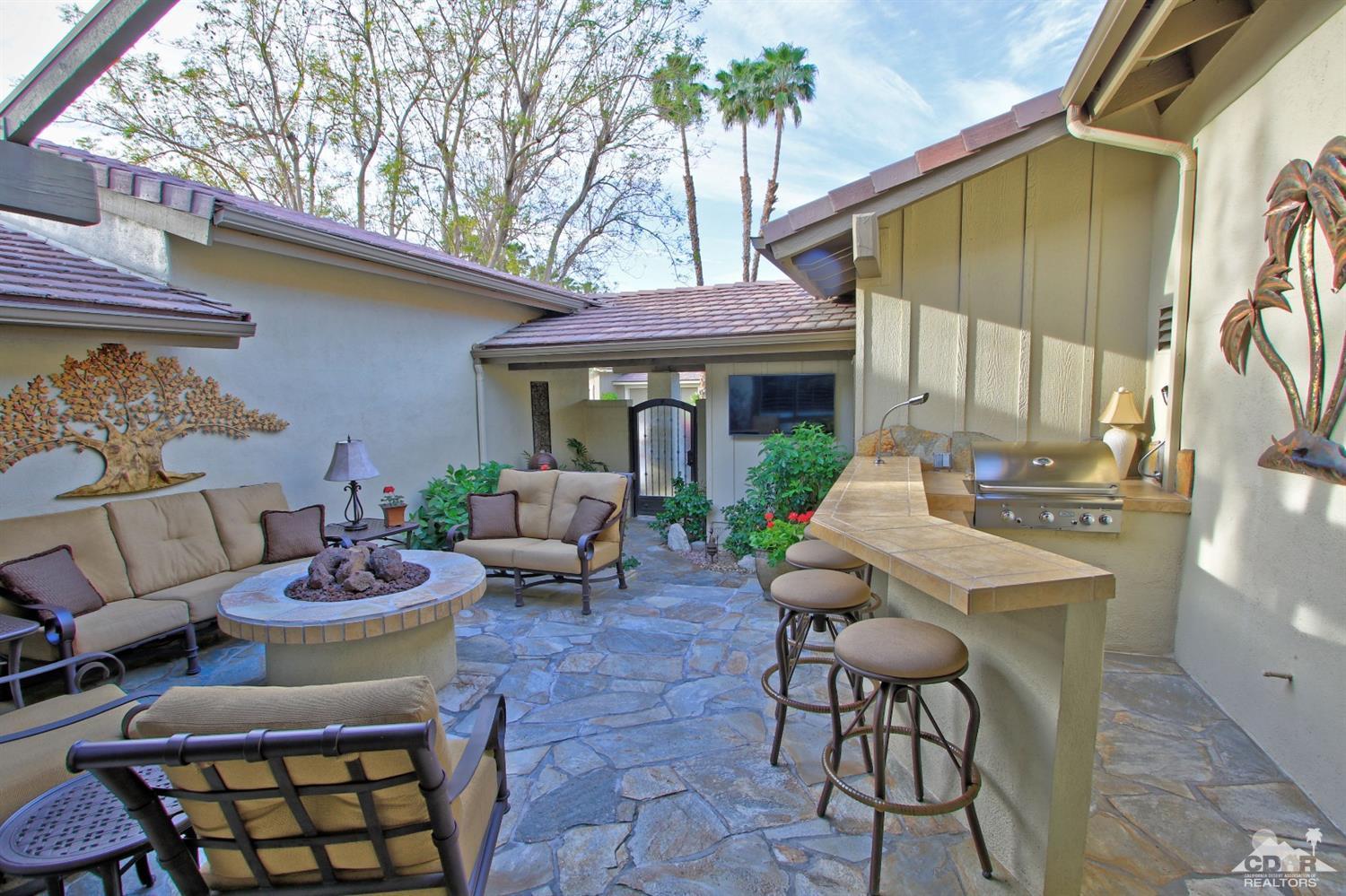 326 Red River Road Palm Desert, CA 92211 - Photo 8 of 54 a view of a patio with couches table and chairs and potted plants