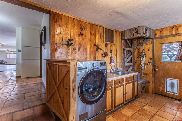 a view of a backyard with wooden floor and iron fence