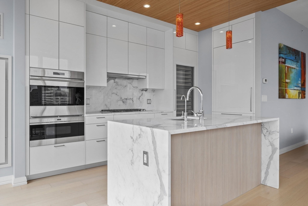 1 Franklin Street, Unit 3808 Boston, MA 02110 - Photo 11 of 40 a kitchen with stainless steel appliances granite countertop a sink and cabinets