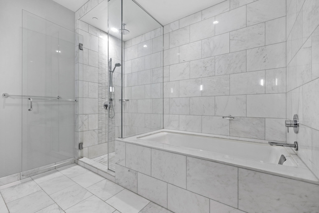 1 Franklin Street, Unit 3808 Boston, MA 02110 - Photo 18 of 40 a bathroom with a bathtub and a shower