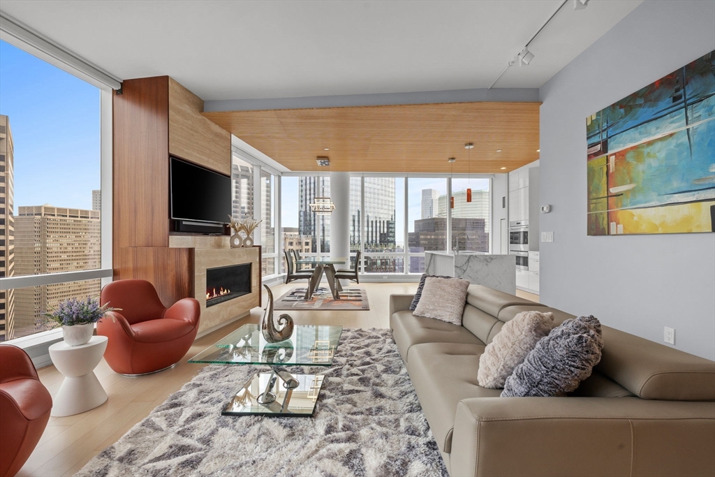 1 Franklin Street, Unit 3808 Boston, MA 02110 - Photo 2 of 40 a living room with furniture fireplace and a flat screen tv