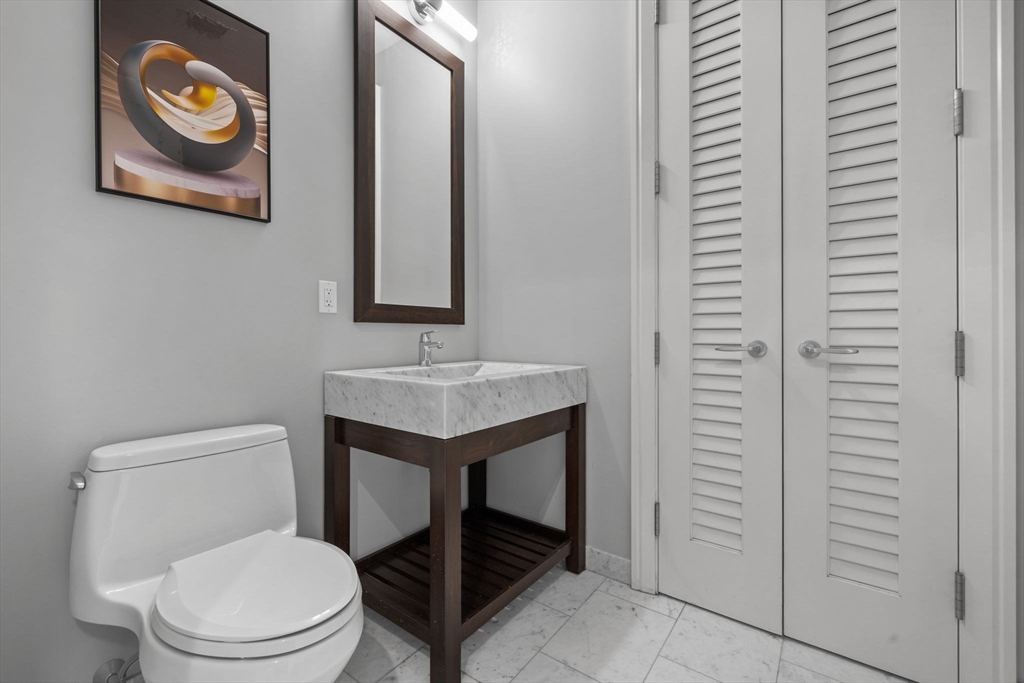 1 Franklin Street, Unit 3808 Boston, MA 02110 - Photo 23 of 40 a white toilet sitting next to a bathroom sink