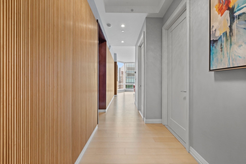 1 Franklin Street, Unit 3808 Boston, MA 02110 - Photo 25 of 40 a view of a hallway with wooden floor