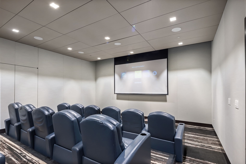 1 Franklin Street, Unit 3808 Boston, MA 02110 - Photo 31 of 40 a media room with lots of chairs and a projector screen