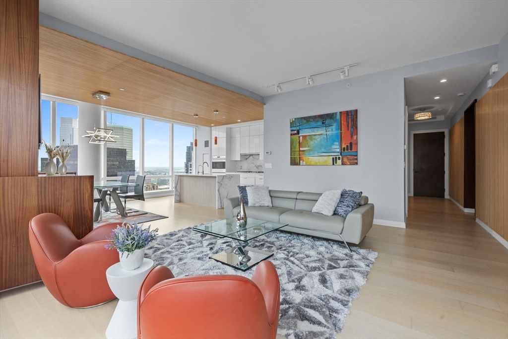 1 Franklin Street, Unit 3808 Boston, MA 02110 - Photo 4 of 40 a living room with furniture and a view of kitchen